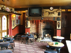Top bar at Prince of Wales Pub Weybridge Surrey - Fireplace has roaring log fire in winter